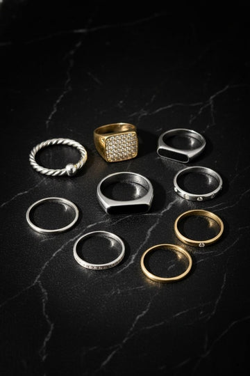 Collection of various rings on a dark marble surface