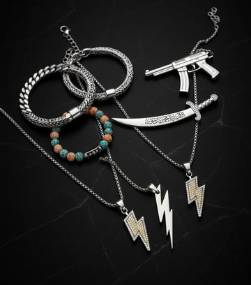 Collection of silver necklaces with various pendants on a dark background