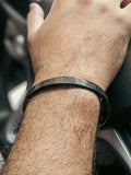 Black Ayat-ul-Kursi bracelet worn on hand – stylish Islamic accessory with Quran verse
