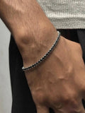 Close-up of black tennis bracelet chain links - Dazzle jewelry