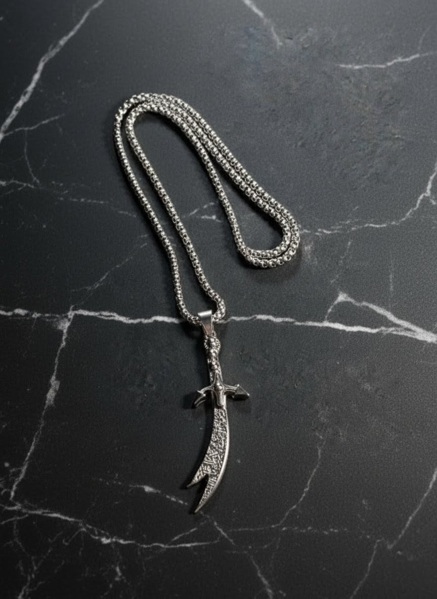 Silver necklace with a unique pendant on a dark marble surface