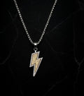 Necklace with a lightning bolt pendant on a dark marble background